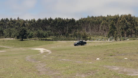 Pickup-truck-driving-across-big-plain