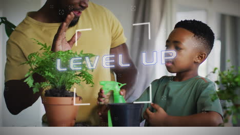 animation of level up text in white over happy african american father and son high fiving at home