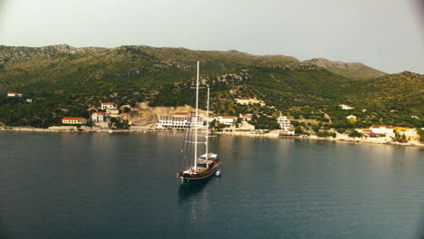 aerial circle shot around a sailboat in a little croatian lake