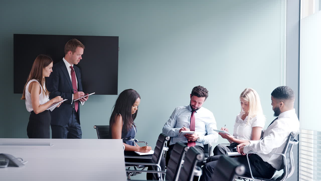 grupo que colabora en una tarea en el día de evaluación de la contratación de graduados mientras es observado por el equipo de contratación