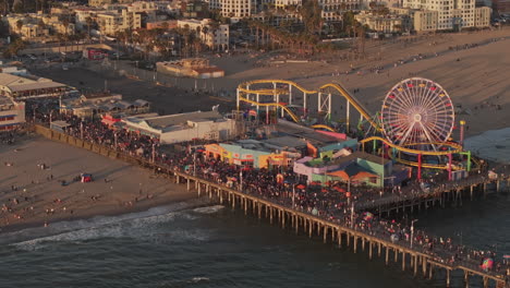 santa monica california aerial v18 zoomed birds eye view flyover and around state beach capturing pacific park on the pier, packed with visitors at sunset - shot with mavic 3 pro cine - may 25th 2024