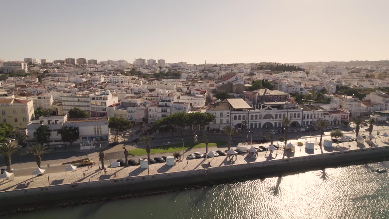 Riverside promenade against Lagos, Algarve, cityscape on sunny day