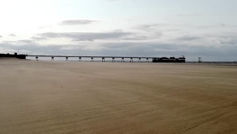 Wunderschöne-Aufnahme-Des-Piers-Bei-Tag-Mit-Blick-Auf-Einen-Fantastischen-Strand