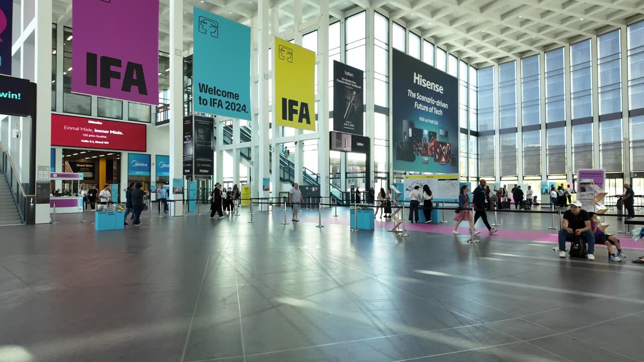 View inside the Messe Berlin Convention Center during the IFA Berlin event, showcasing technology displays and banners in a spacious hall.