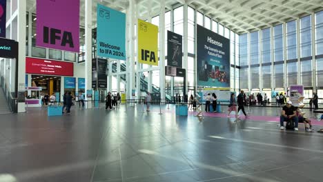 view inside the messe berlin convention center during the ifa berlin event, showcasing technology displays and banners in a spacious hall.