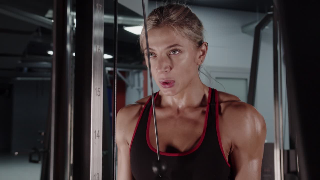 Woman working out on a cable machine at the gym