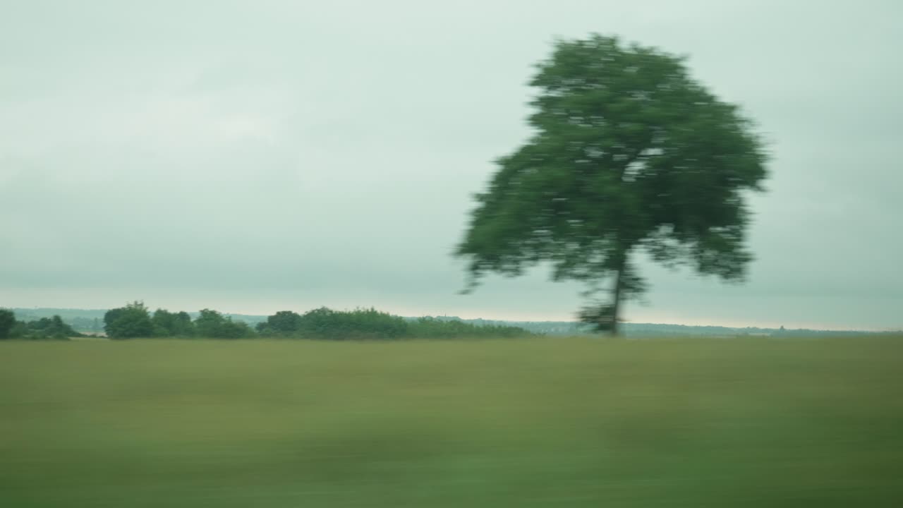 POV View From Window On Train Going Past Rural Countryside In France. Follow Shot
