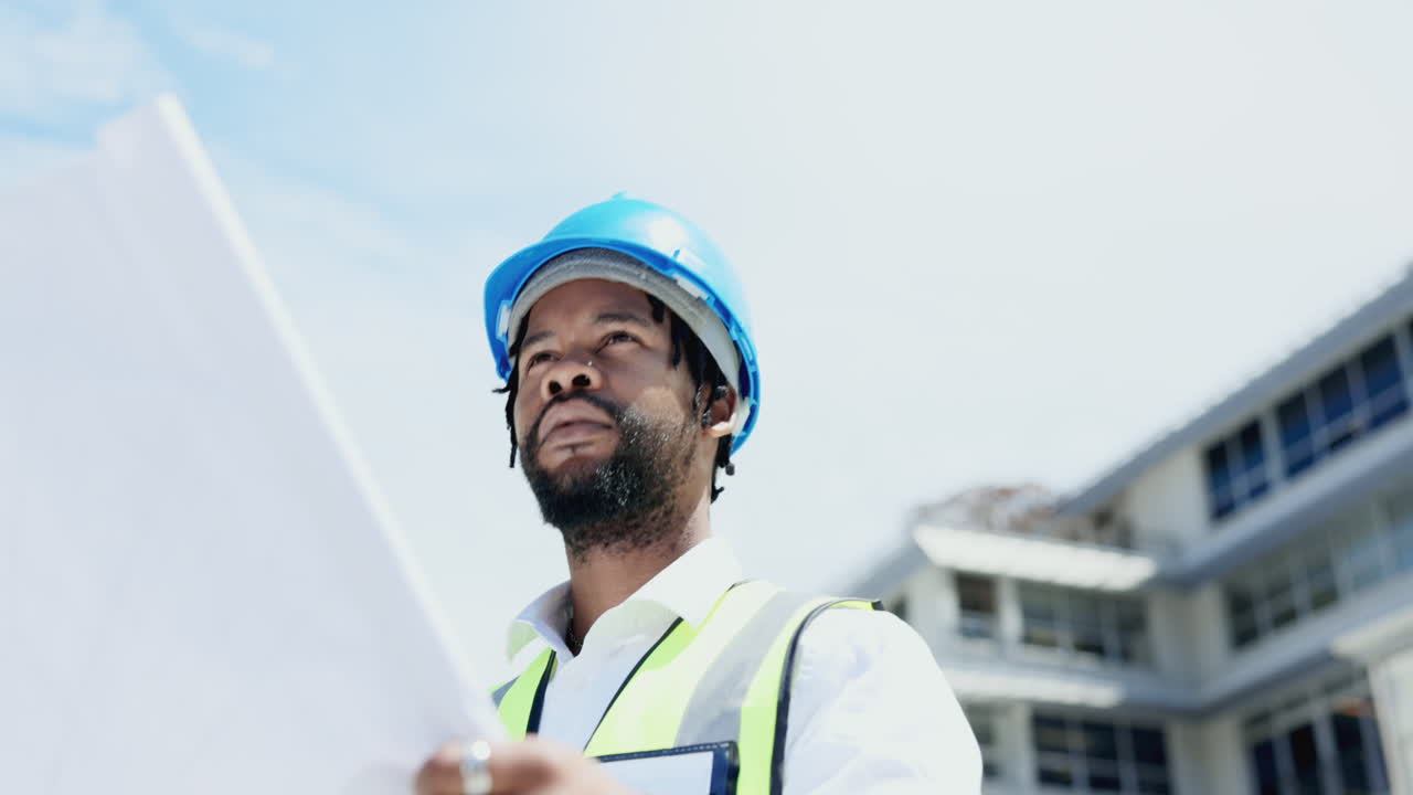 Black man, architect and blueprint in disagreement