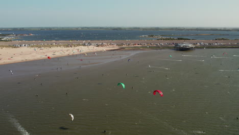 group kitesurfing at brouwersdam beach in the netherlands - aerial shot