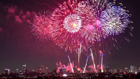 colorful fireworks light up the night sky over a city skyline, creating a vibrant and festive atmosphere during a special event celebration