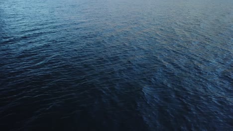 waves generated by the wind on dark blue water surface