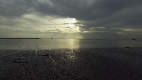 scenery of low tide at sunset, drone shot, low flying