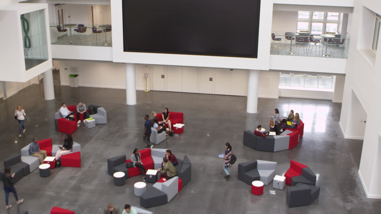Overhead handheld tilt shot of university atrium and lobby, shot on R3D