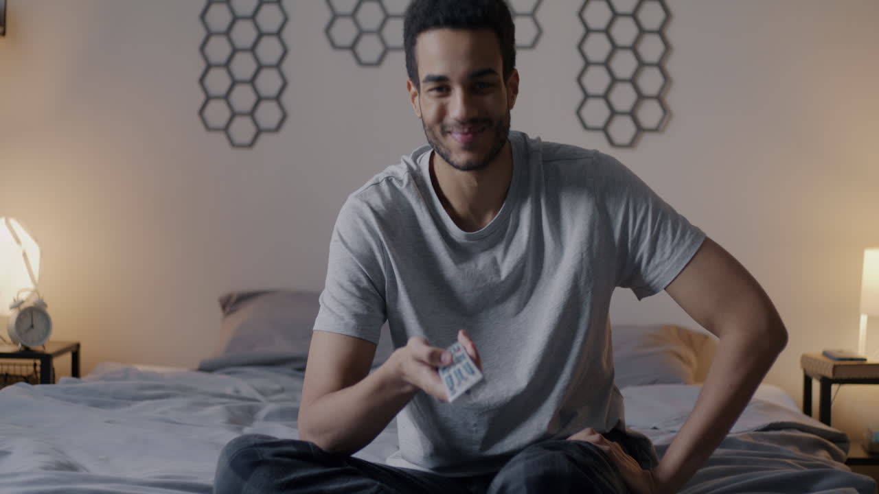 Man watching TV in his bedroom