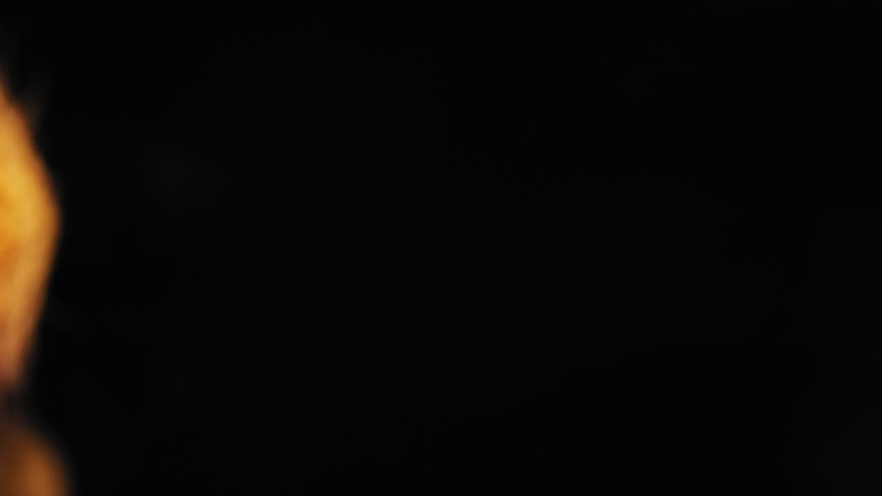 An extreme closeup panning right to left of looking into the head of a makeup brush with a black background