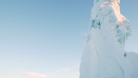 Tall-iceberg-inside-small-town-in-northern-Sweden,-shot-from-below-on-tripod-a-cold-morning-in-mars