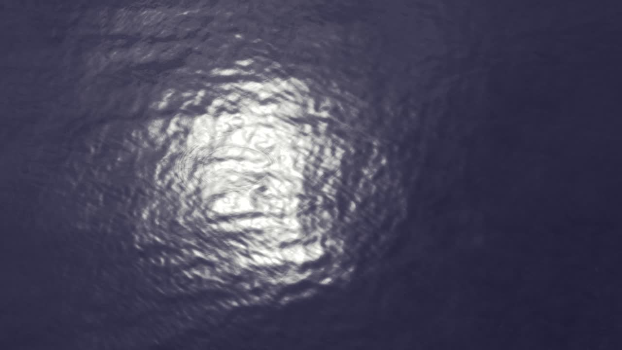Abstract water surface with small waves and sun or moon reflection