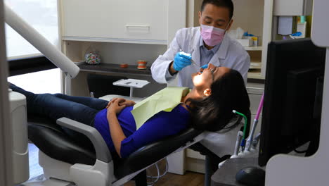 male dentist examining a lady patient 4k