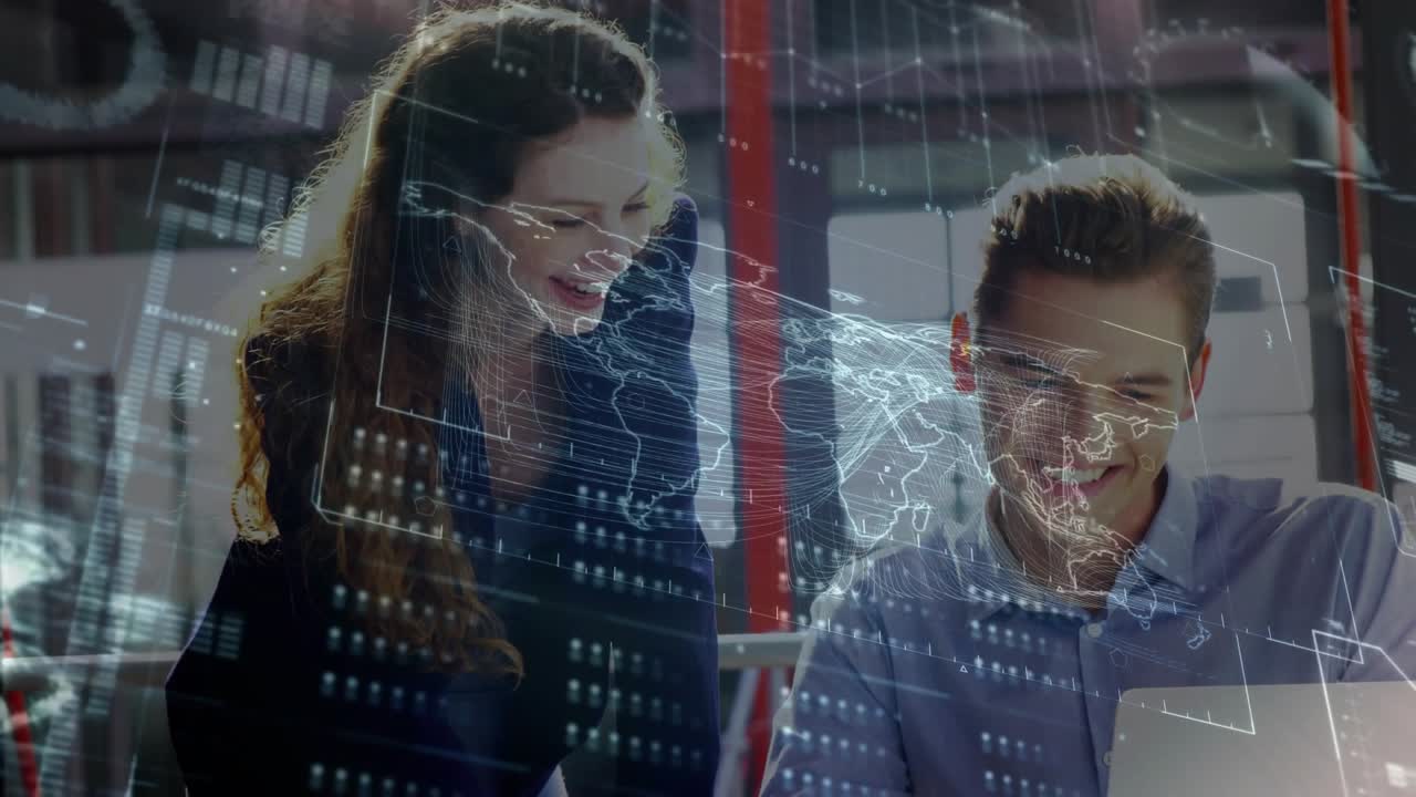 Woman leaning over desk, pointing at laptop, man typing while tech data map sweeping, both smiling