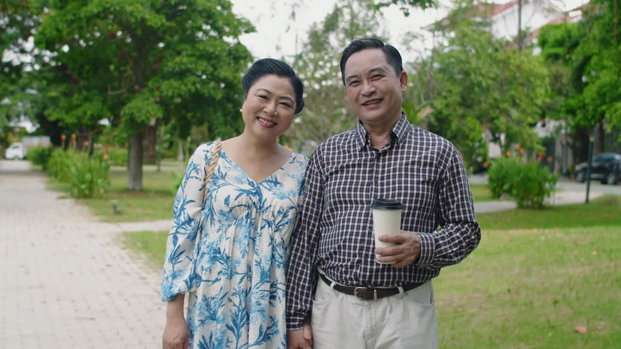 Portrait of Cheerful Senior Wife and Husband in City Park