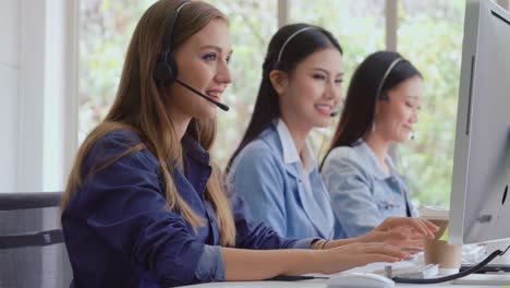 customer support agent or call center with headset talking to customer on phone.