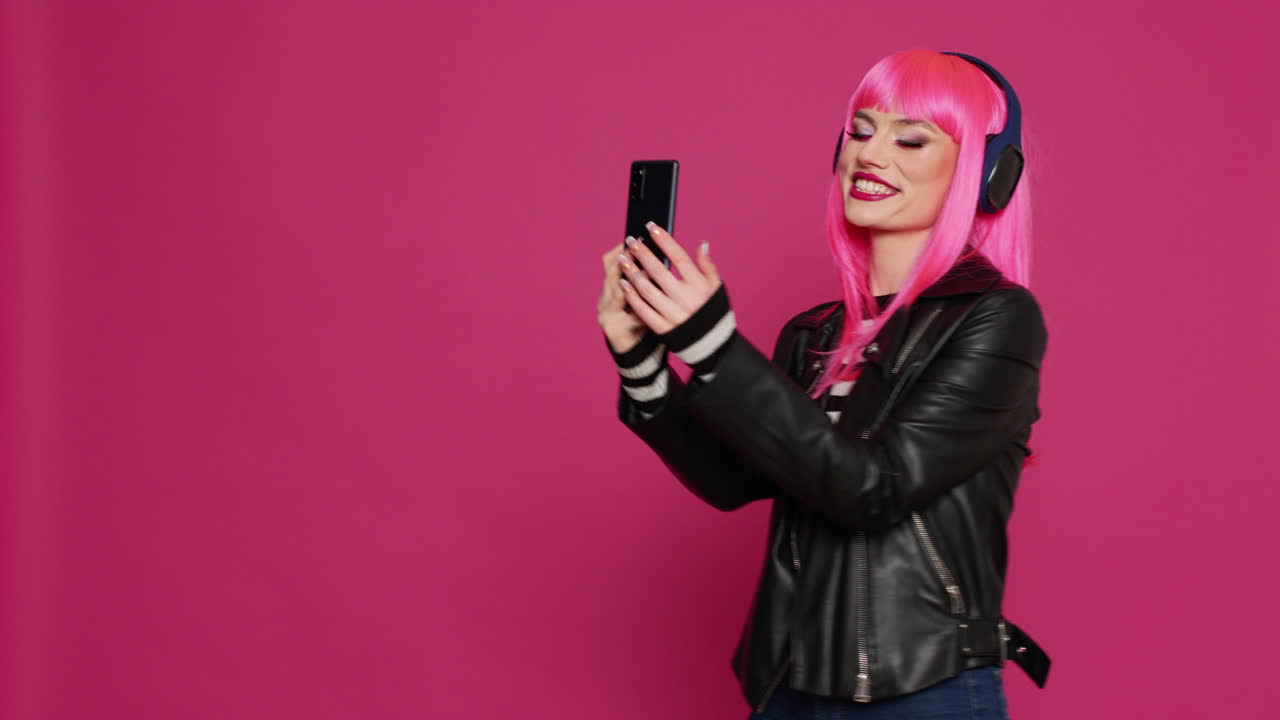 Happy pretty woman taking pictures with mobile phone app