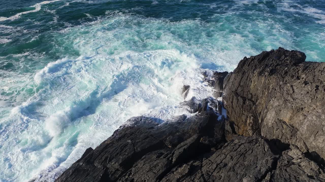 olas rompiendo en la costa rocosa