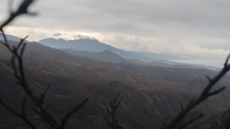 Foggy-rocky-landscape-and-mountains-with-flowing-cloudscape,-time-lapse