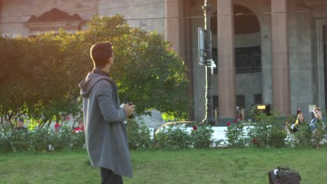 man with camera in a city park