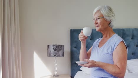 Senior-woman-having-coffee-in-bedroom-4k