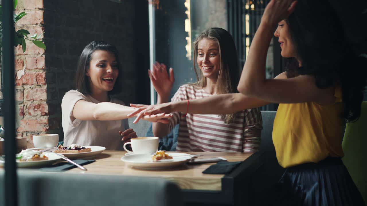 Happy friends having a good time together in a cafe