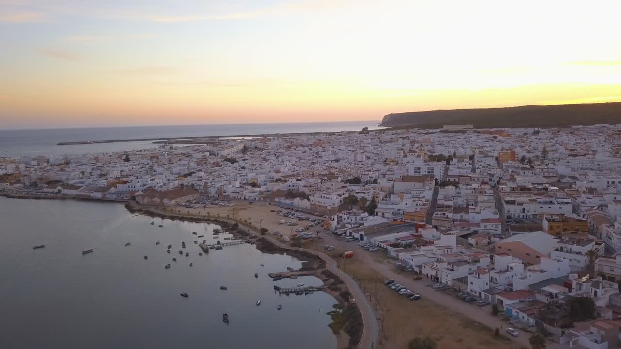 Aerial view of the bautiful fishing town of Barbate in Cadiz with the sunset behind.