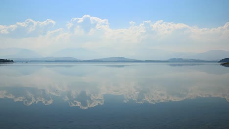 cloudscape over blue waterfront of lake