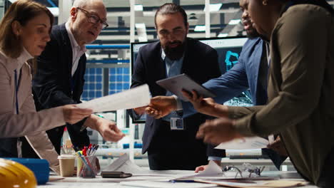 industrial plant managers analyze technical production data on paperwork