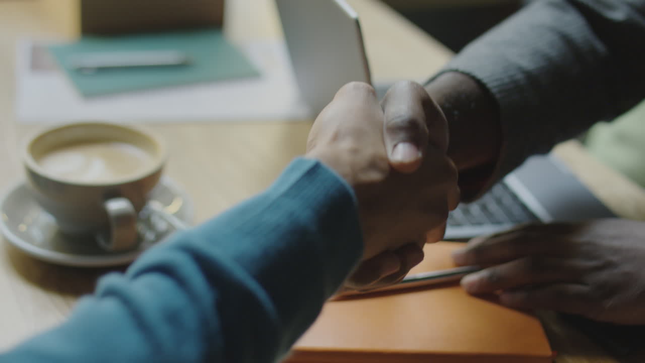 Handshake of Two Business Partners in Cafe