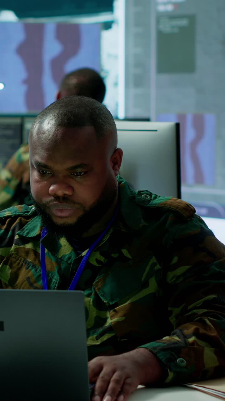 Vertical Video Military intelligence specialist uses high tech satellite systems and cctv radar