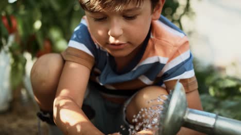 Video-of--boy-washing-his-hands-at-the-watering-can