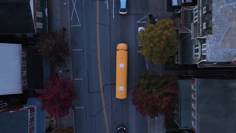 yellow school bus in small town america during autumn morning