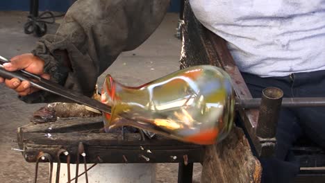 craftsman modelling a glass vase