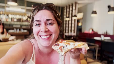 happy woman savoring a slice of tasty pizza