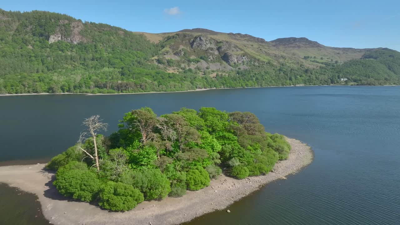 Small island in Cumbrian lake. Flyover. Rampsholme Island, Derwentwater, Lake District, Cumbria, UK.