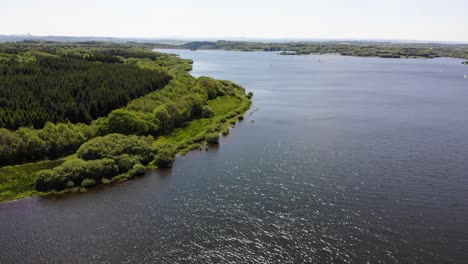 Roadford-Reservoir-With-Lush-Green-Forest-On-Coastline