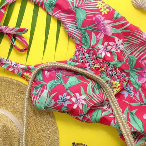 Female-beach-summer-clothes-and-accessories-collage-on-yellow-background