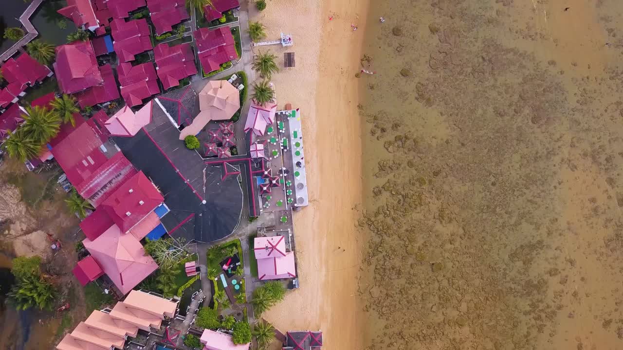 Bird-eye's view aerial shot of Kampung Paya Beach Resort Hotel on Tioman Island, Malaysia