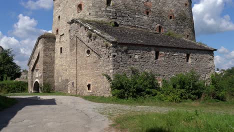 medieval bastion at kamyanets-podilskyi,ukraine on a sunny day. tilt up from ground level towards blue skies with white clouds