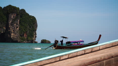 speeding long tail boats boats in the sea off ao nang, krabi, thailand