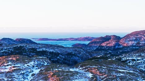 vast landscape of mountains covered in snow at sunset near bessaker, norway