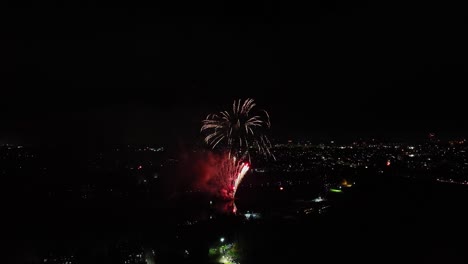 Aerial-shot-of-vibrant-fireworks-being-set-off-on-guy-fawkes-night