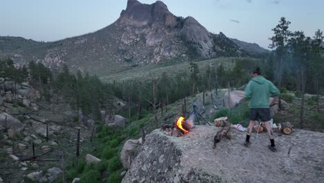 friends makes campfire on boulder with views of sheeprock, san isabel