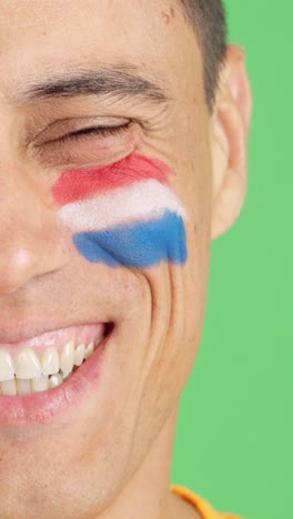man with a dutch flag painted on the face smiling
